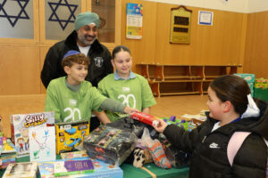 Harj Sethi from Nishkam SWAT and WIJPs' Head Boy and Girl man the collection stand