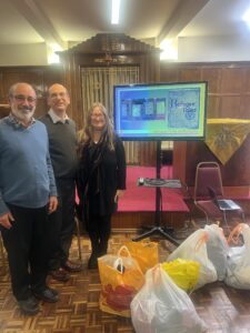 Stephen Klein, Rabbi Richard Jacobi and Anna Pincus with the ELELS collection of clothing