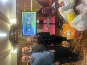 Stephen Klein, Rabbi Richard Jacobi and Anna Pincus with the ELELS collection of clothing