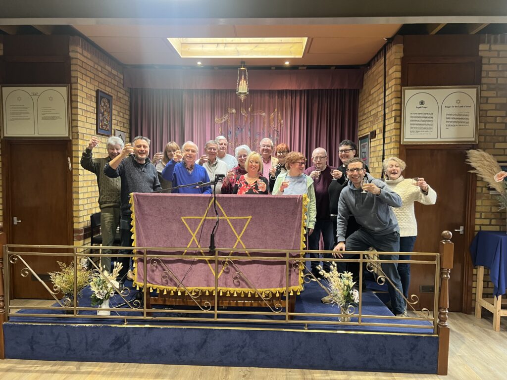 Council members of the two communities come together to celebrate the merger