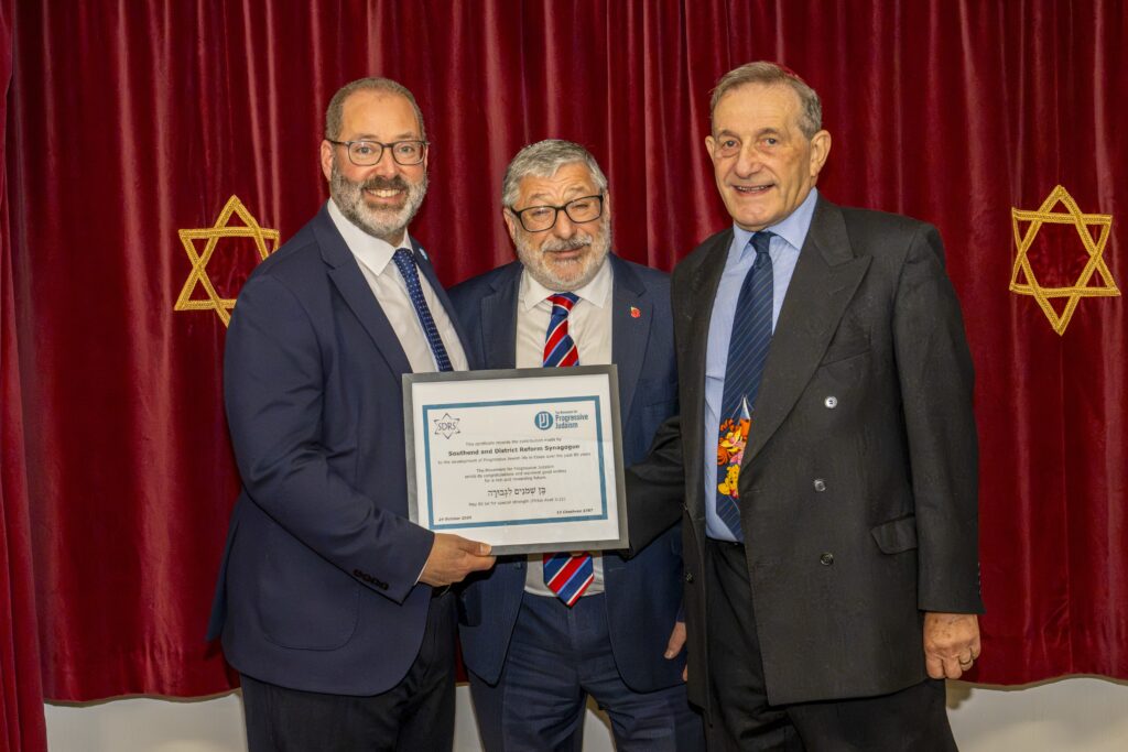 Rabbi Josh Levy presents Southend and District Reform Synagogue's Chair Lewis Miller and Rabbi Warren Elf with a certificate of recognition for its contribution to Progressive Jewish life in Essex